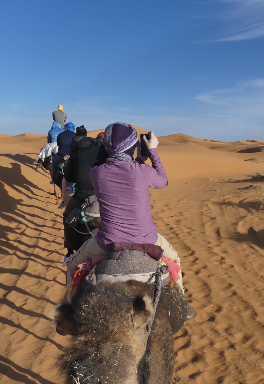 Riding a camel in the Sahara